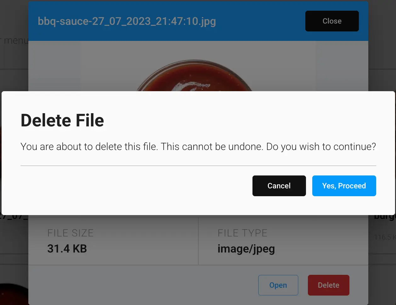 The Delete File confirmation dialog in the GrubStack Core dashboard, showing the file's size and type behind the confirmation prompt